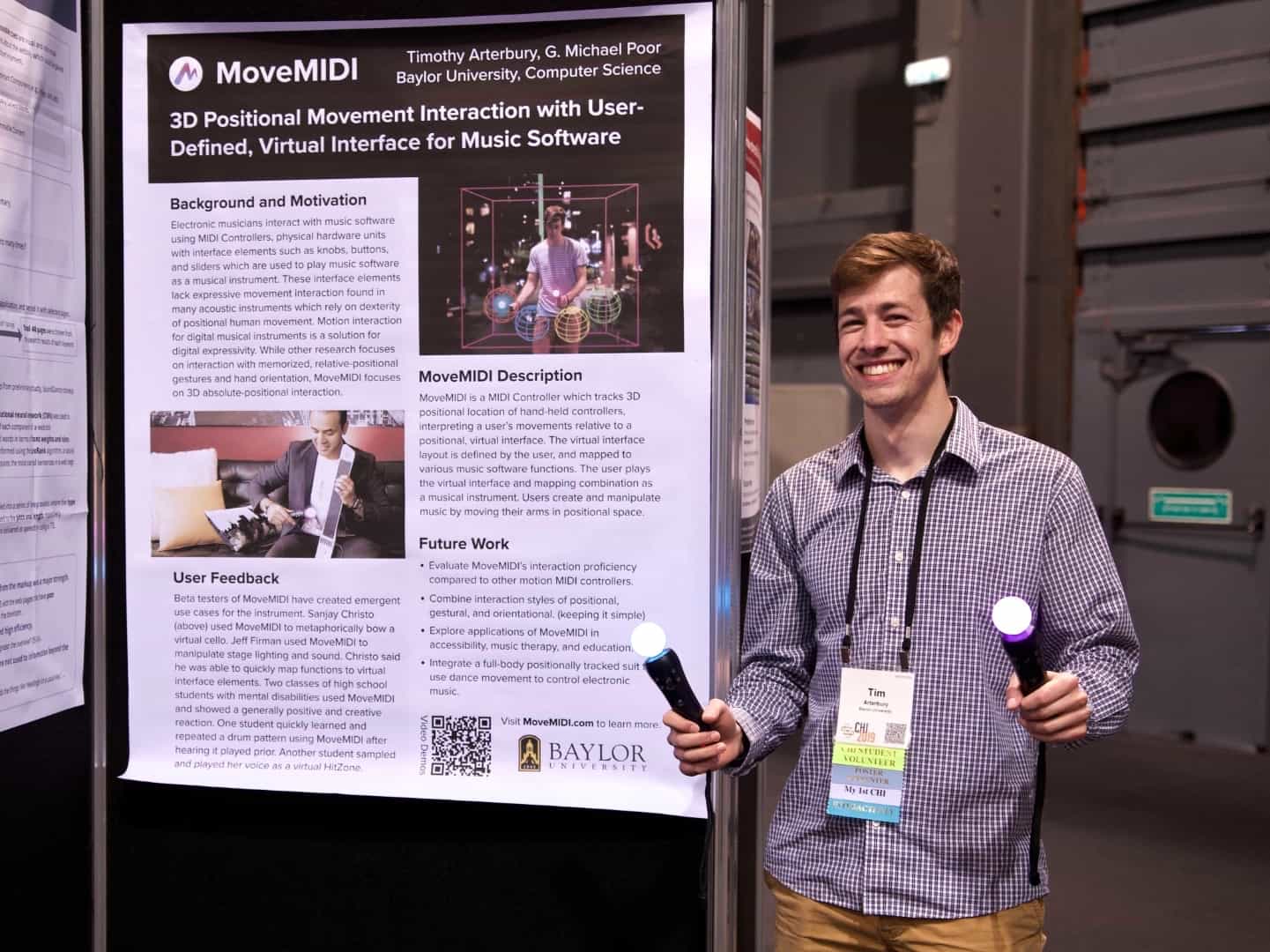 Photo of Tim standing in front of his research poster.